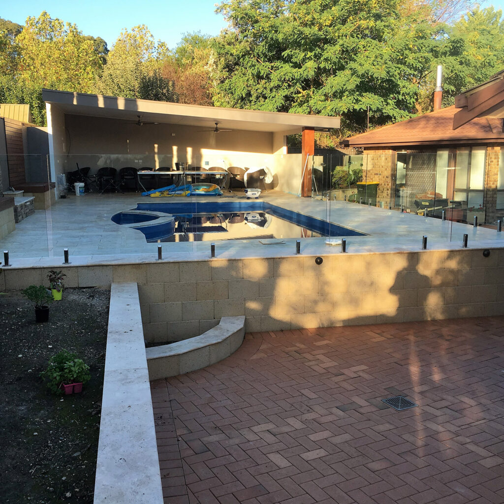 Freestone retaining wall and pool paving after